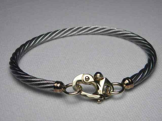 Appraisal: Bangle bracelet of twisted steel with unusual kt gold clasp