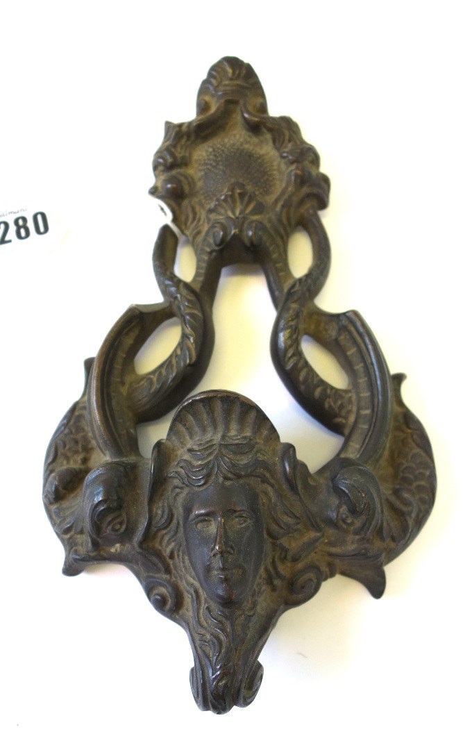 Appraisal: A Georgian bronze door knocker with shell scroll finial over