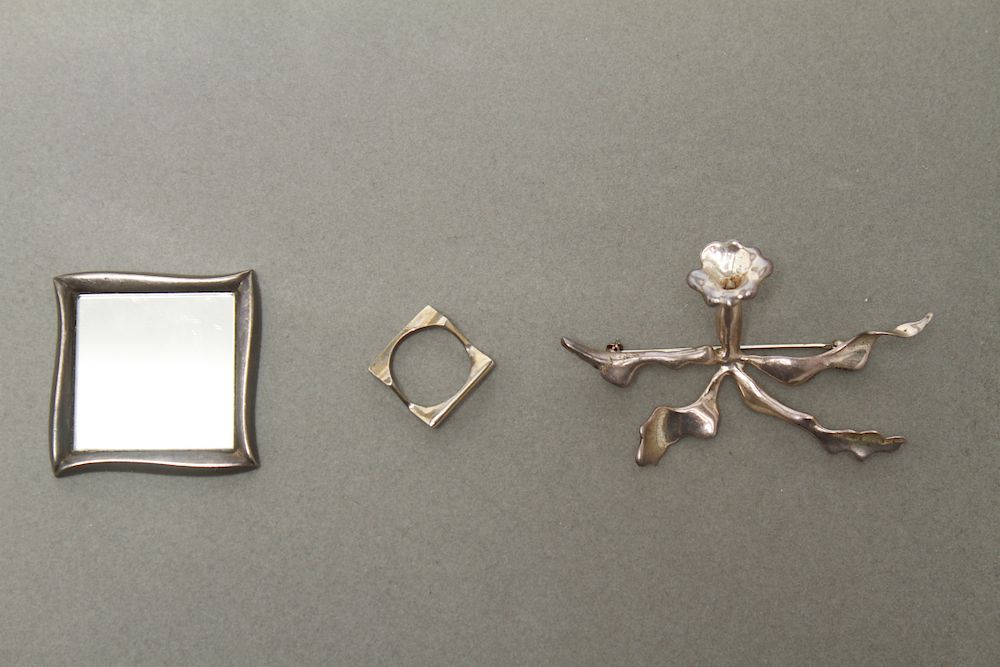 Appraisal: Angela Cummings Silver Brooch Mirror One Other Three silver accessories