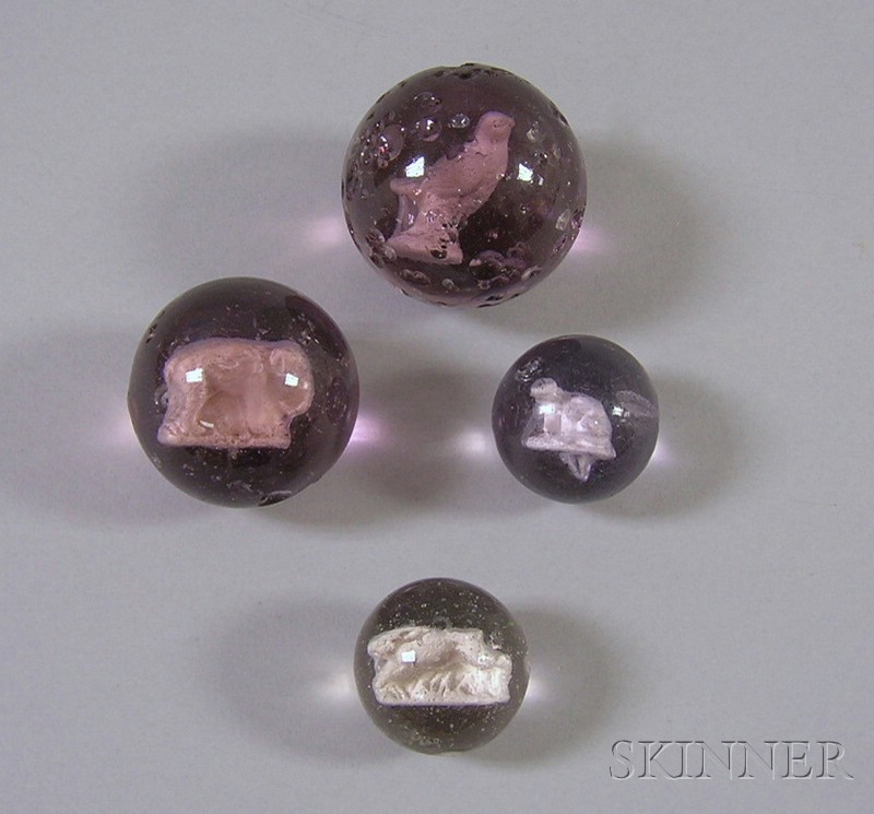 Appraisal: Four Sulfide Glass Marbles including amethyst otter elephant and bird