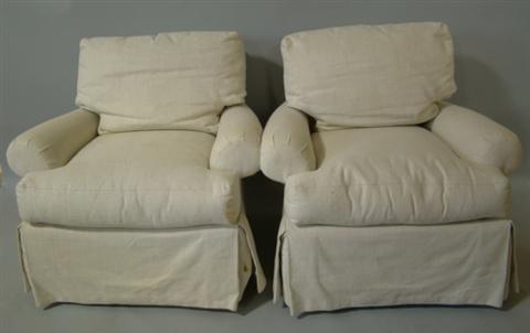 Appraisal: A PAIR OF SWIVEL ARM CHAIRS UPHOLSTERED IN CREAM LINEN