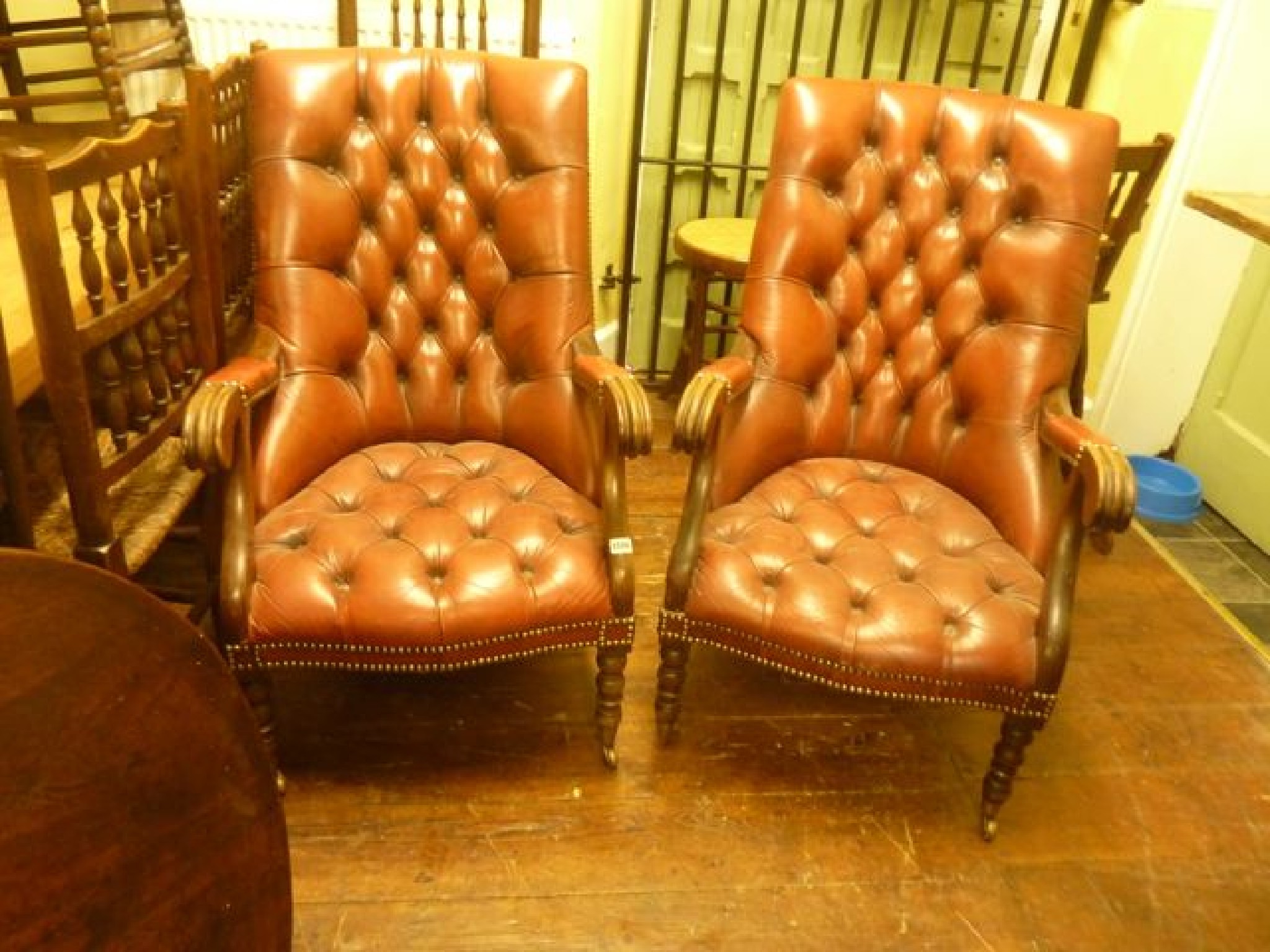 Appraisal: A pair of good quality reproduction open armchairs with buttoned