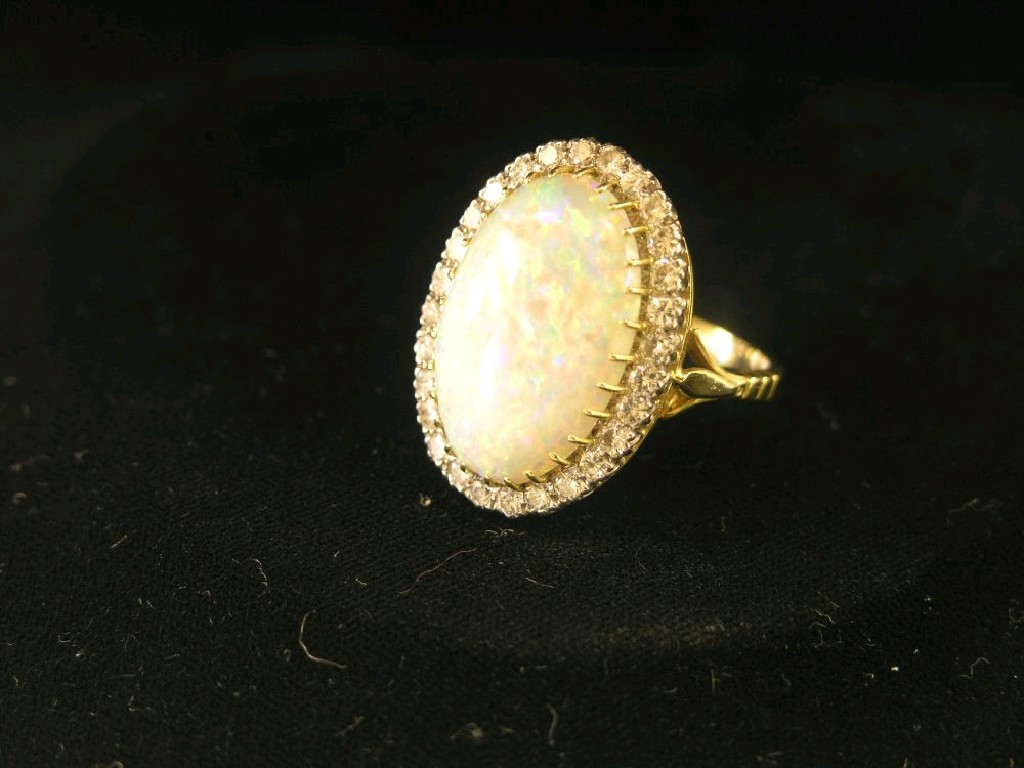 Appraisal: A large ct gold opal and diamond ring single oval