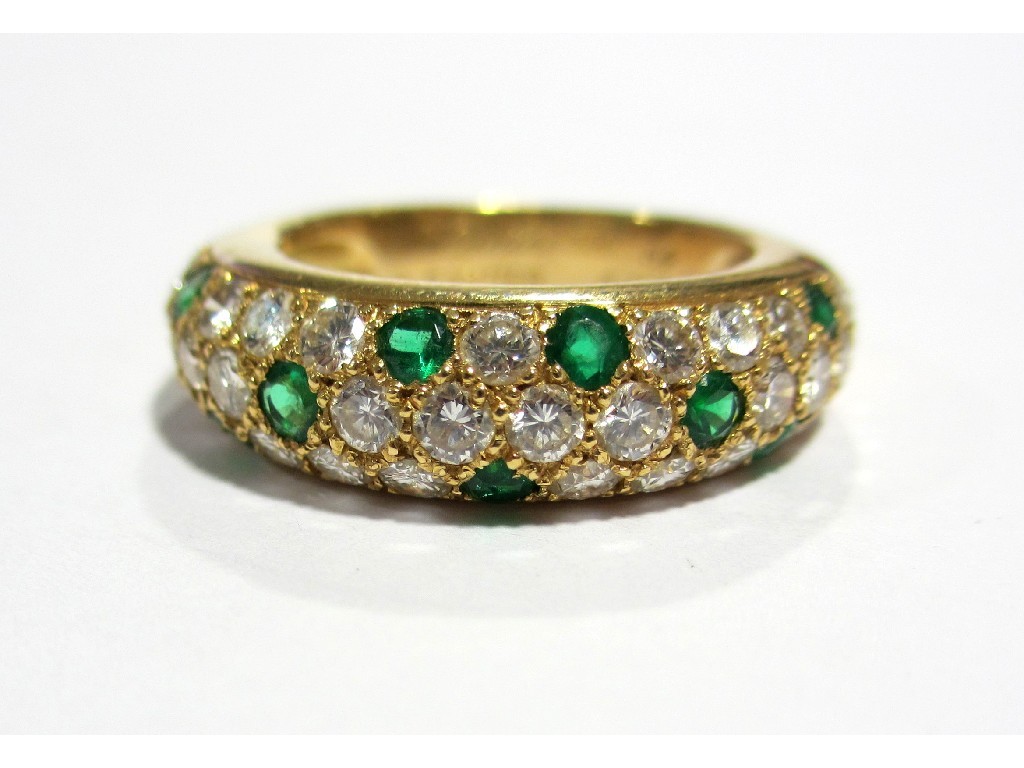 Appraisal: A Cartier ct yellow gold emerald and diamond set band