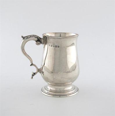 Appraisal: A George III baluster mug on a spreading foot with