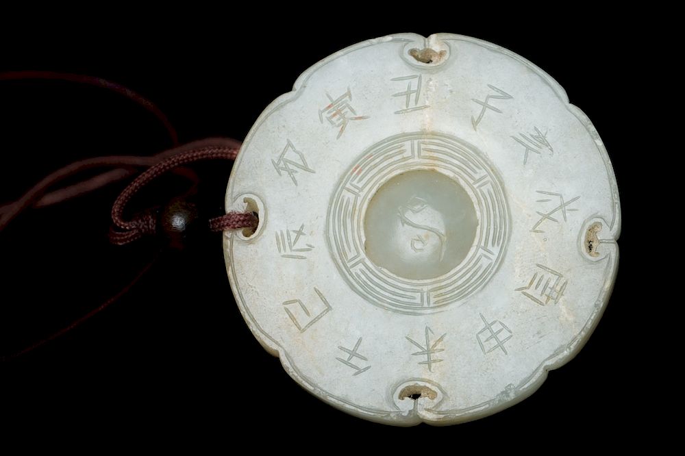 Appraisal: BAGUA' JADE PLAQUE A circular pendant of eight-lobes with a