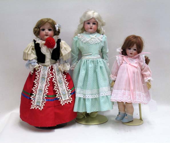 Appraisal: THREE GERMAN BISQUE HEAD GIRL DOLLS The first by Schoenau