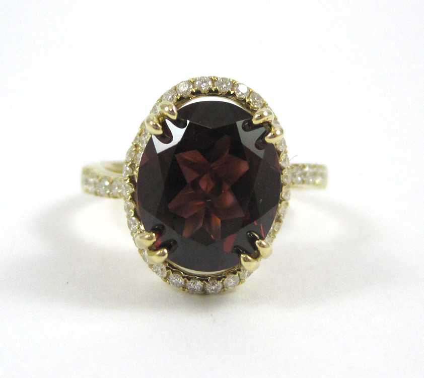 Appraisal: GARNET DIAMOND AND FOURTEEN KARAT GOLD RING with round-cut diamonds