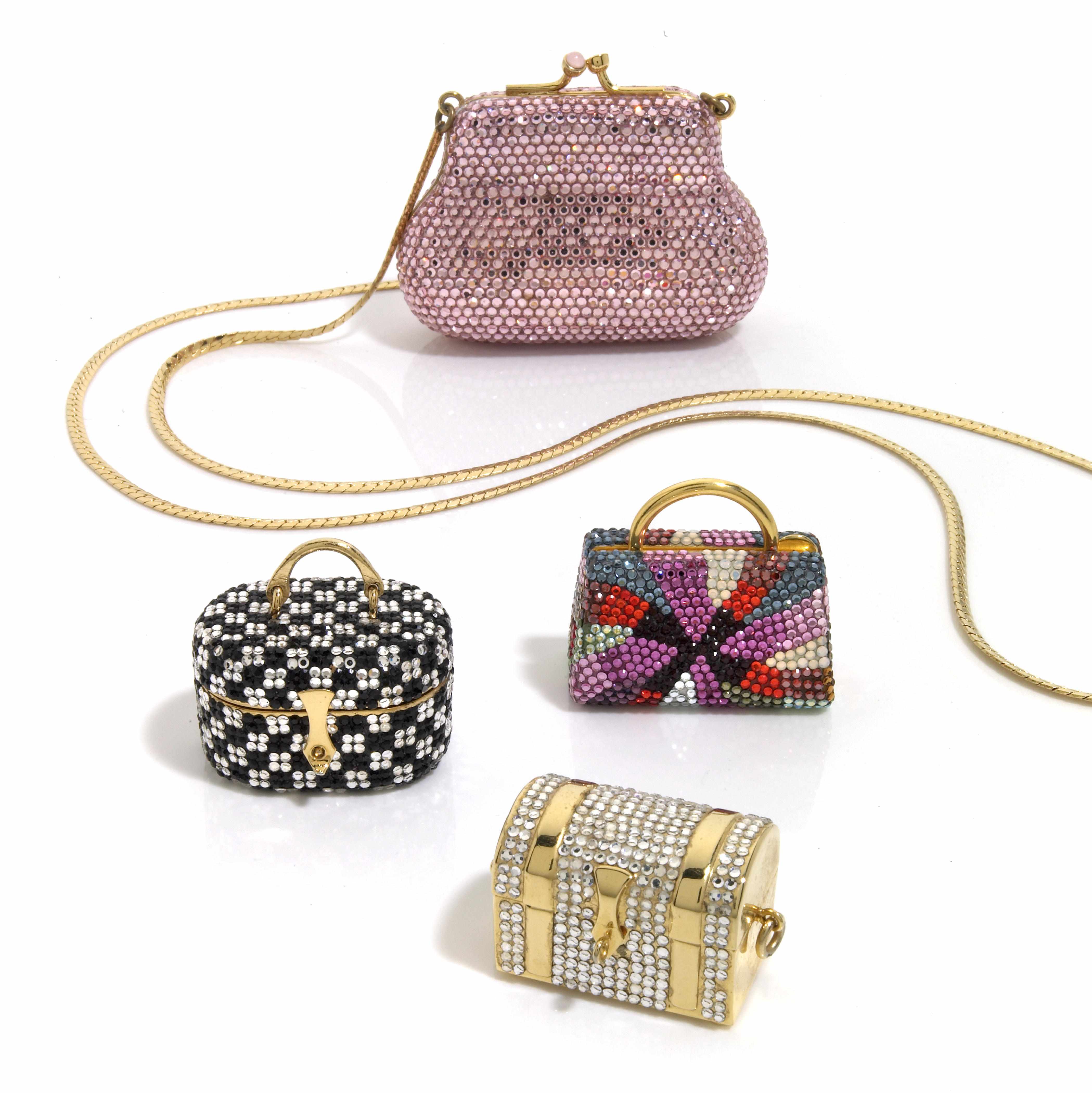 Appraisal: A collection of three multi-colored crystal ''luggage'' pillboxes and one