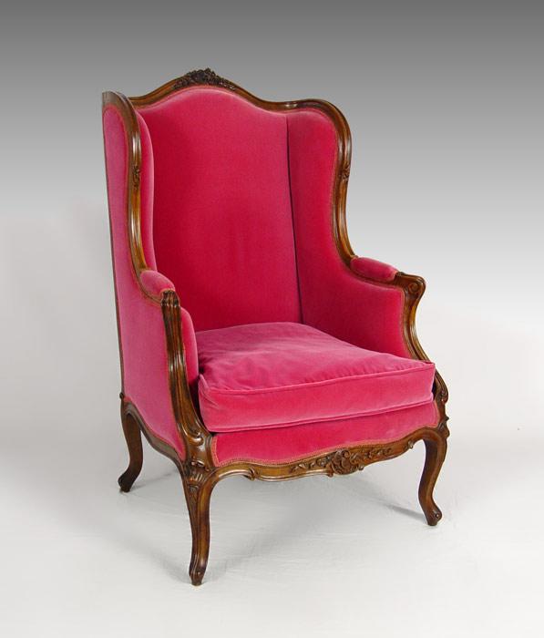 Appraisal: CARVED FRENCH STYLE MAGENTA VELVET WING CHAIR Carved walnut frame