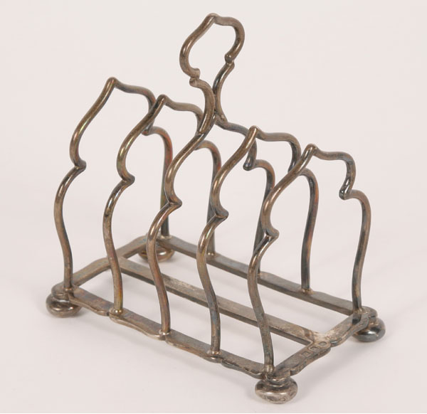 Appraisal: English sterling silver toast rack footed base four racks in