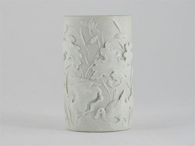 Appraisal: A Chinese cylindrical brushpot moulded in high relief with two