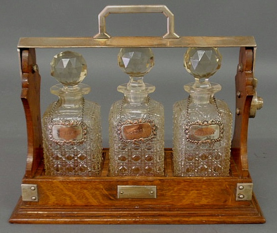 Appraisal: Oak cased tantalus with three crystal decanters c with chrome