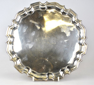 Appraisal: A silver pie-crust salver on three scroll feet Walker Hall