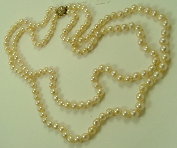 Appraisal: OPERA LENGTH DOUBLE STRAND PEARL NECKLACE K yellow gold dome