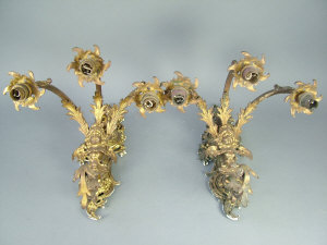 Appraisal: A pair of gilt brass triple branch wall lights profusely