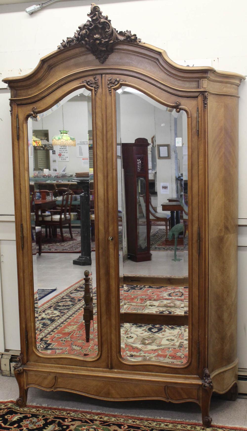 Appraisal: LOUIS XV STYLE DOUBLE-DOOR WALNUT ARMOIRE French c the doors