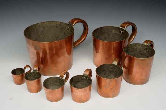 Appraisal: A GRADUATED SET OF COPPER NAVAL RUM MEASURES each with