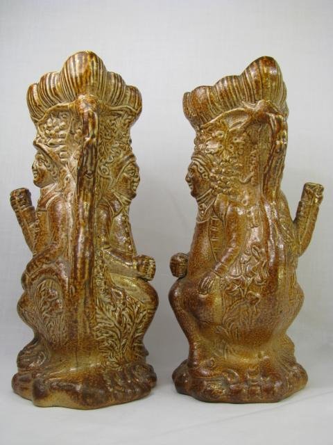 Appraisal: Pair of earthenware bud vases of a man sitting down