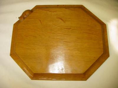 Appraisal: AN ADZED OAK BREADBOARD by Robert Mouseman Thompson of canted