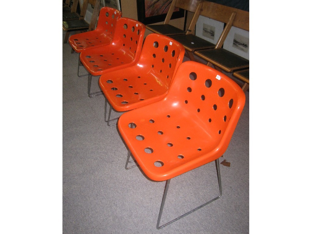 Appraisal: Set of four orange plastic chairs by Robin Day