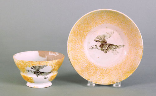 Appraisal: Yellow spatter cup and saucer th c with transfer eagle