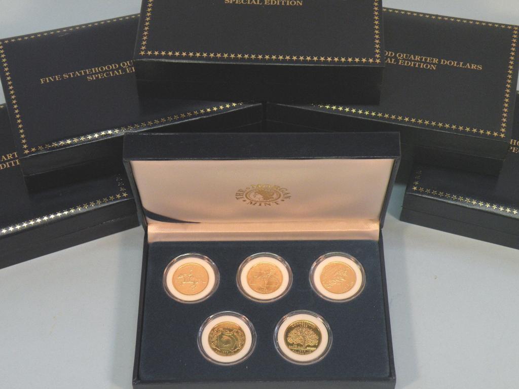 Appraisal: Seven sets of gold plated commemorative dollars the Morgan Mint