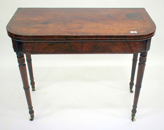 Appraisal: A GEORGIAN MAHOGANY FOLD OVER CARD TABLE with rounded front