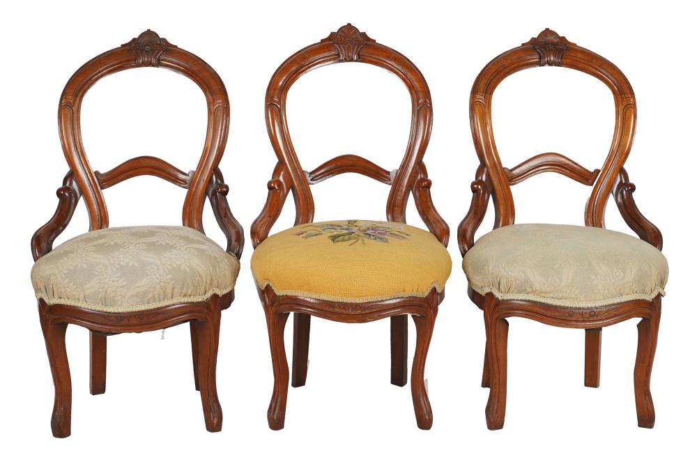 Appraisal: THREE VICTORIAN BALLOON BACK SIDE CHAIRScarved mahogany with upholstered seats