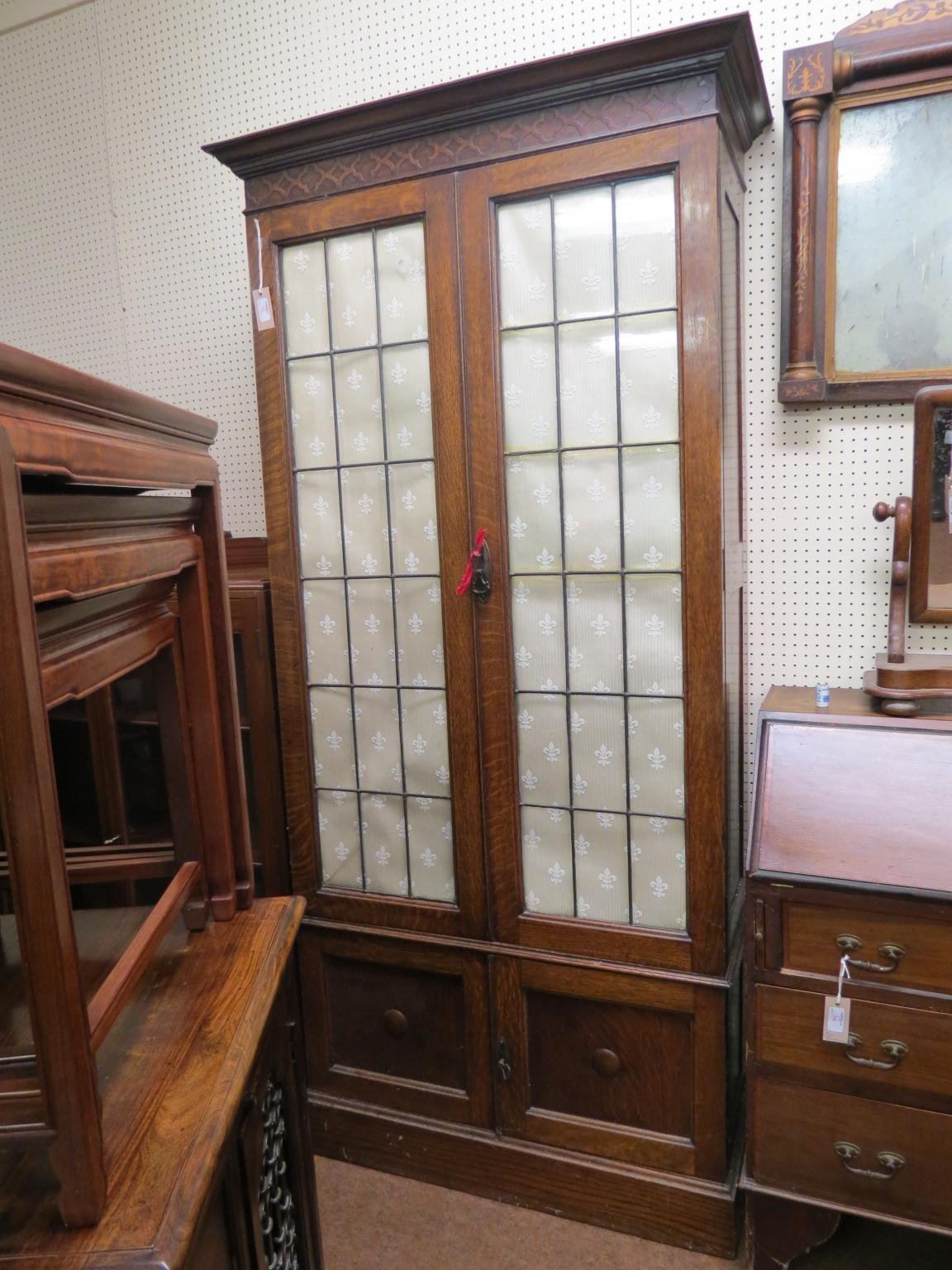 Appraisal: An early th century solid dark oak bookcase floor-standing pair