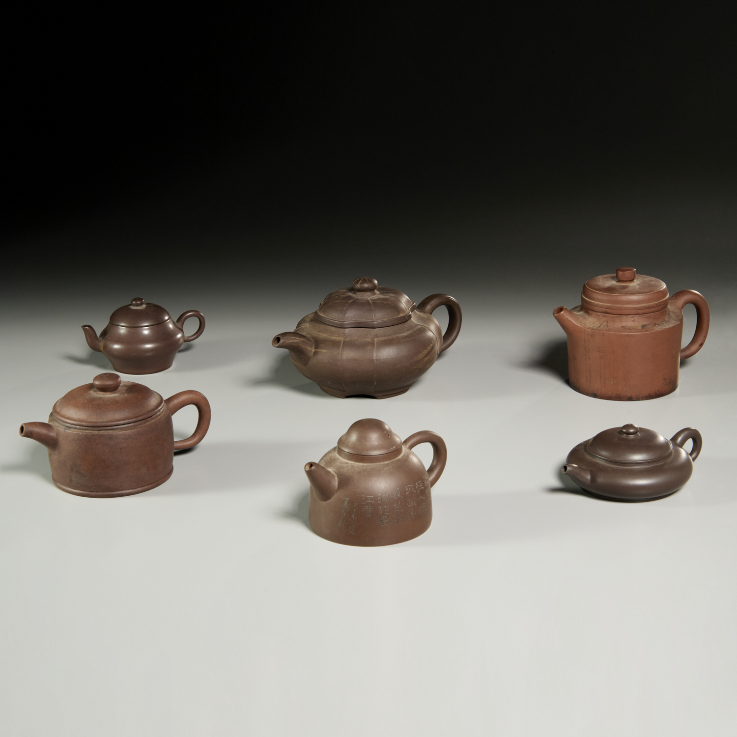 Appraisal: CHINESE SCHOOL SIGNED YIXING TEAPOTS Chinese School th th c