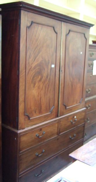 Appraisal: A late th century mahogany linen press the panelled doors