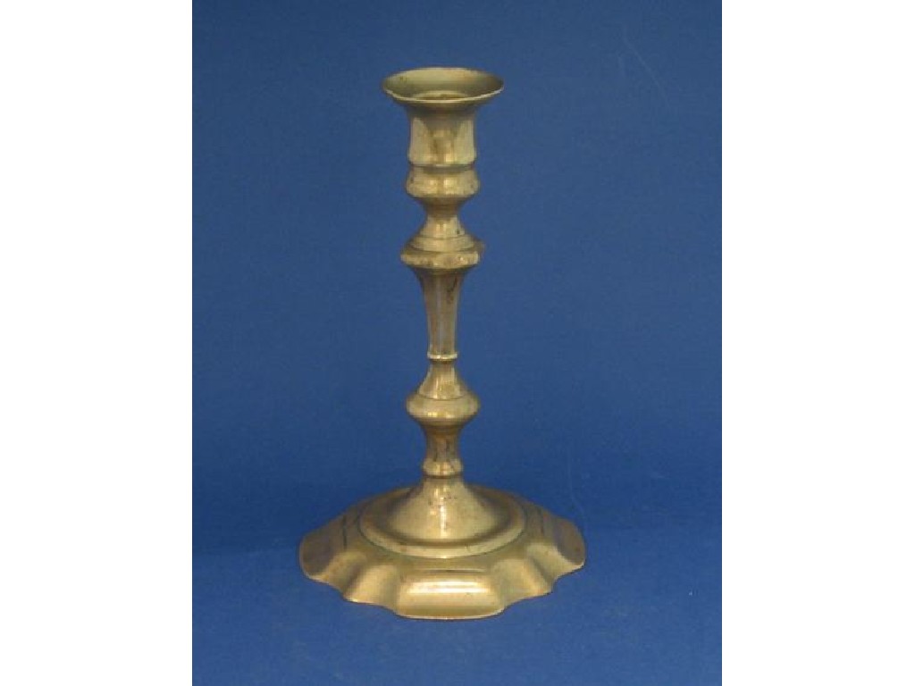 Appraisal: AN EARLY GEORGE III BRASS CANDLESTICK on spreading shaped base