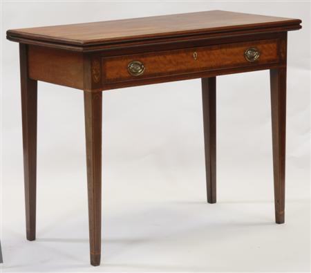 Appraisal: A mahogany foldover tea table the moulded rectangular top over