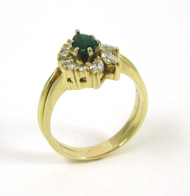 Appraisal: FOURTEEN KARAT GOLD DIAMOND AND EMERALD RING the single pear-cut