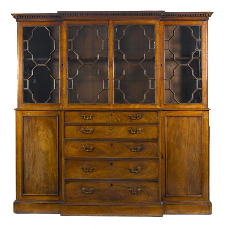 Appraisal: A GEORGE III MAHOGANY BREAKFRONT BOOKCASE with dentil cornice and