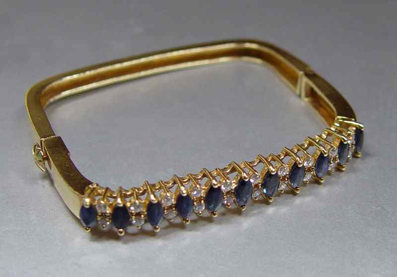 Appraisal: K SAPPHIRE AND DIAMOND SQUARE BANGLE BRACELET K yellow gold