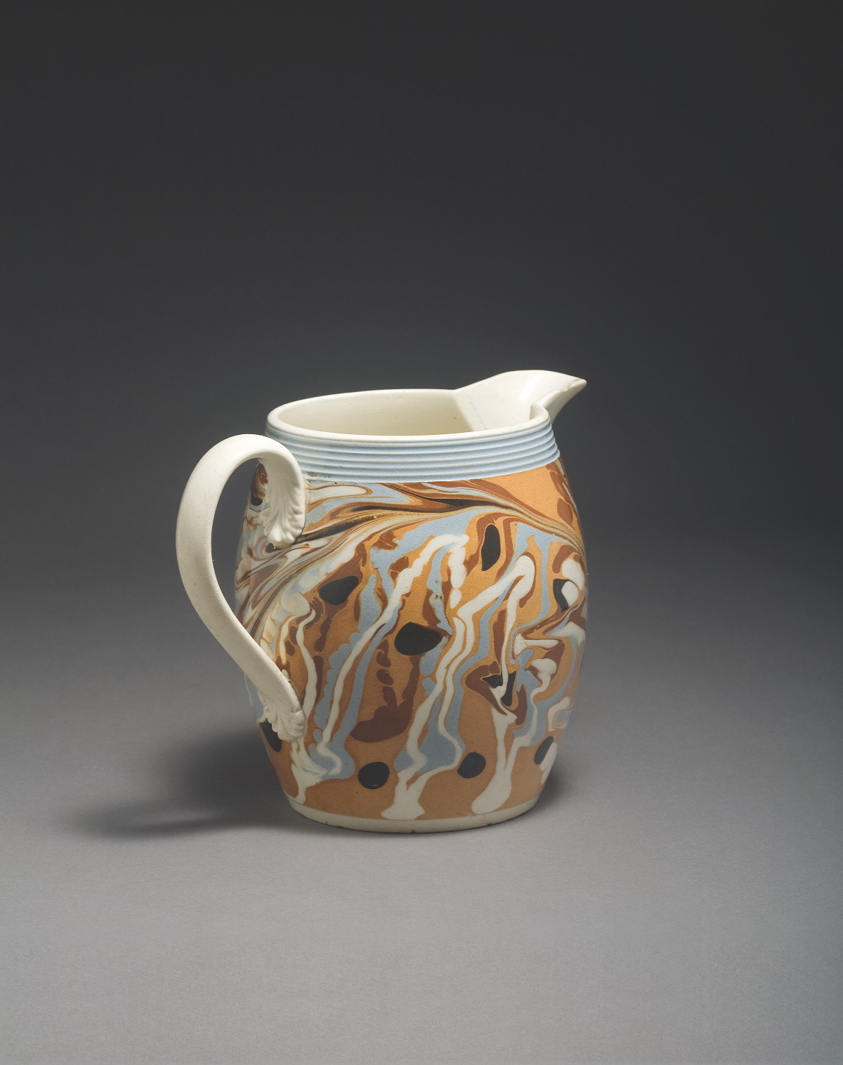 Appraisal: BRITISH PEARLWARE MOCHAWARE JUG CIRCA - Of barrel form slip-marbled