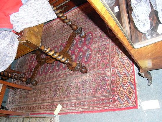 Appraisal: A BOKHARA TYPE RUG of red ground with elephant foot