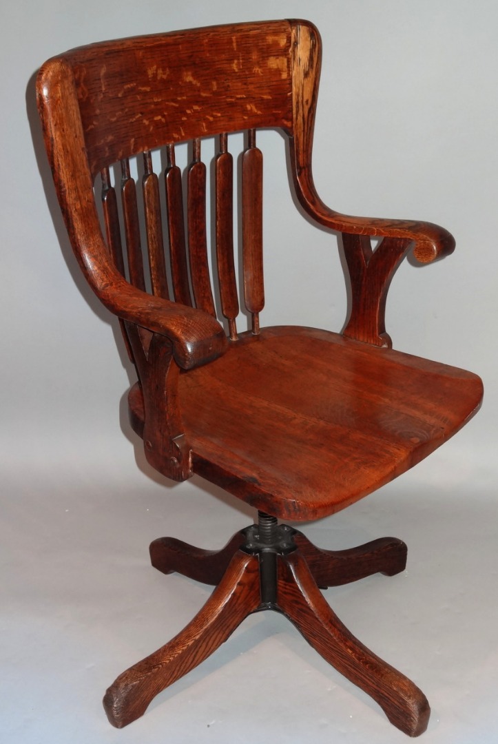 Appraisal: A 's oak office chair with a heavy back above