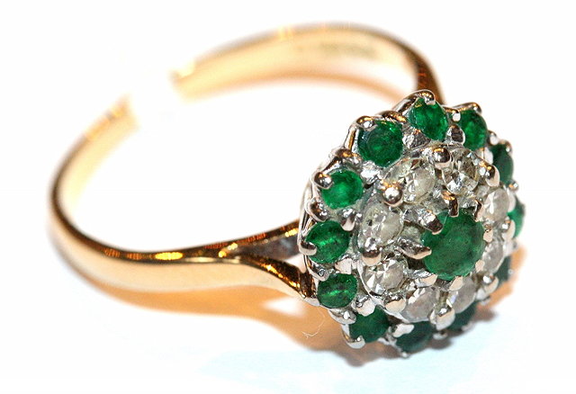 Appraisal: AN EMERALD AND DIAMOND SET DRESS RING in the form