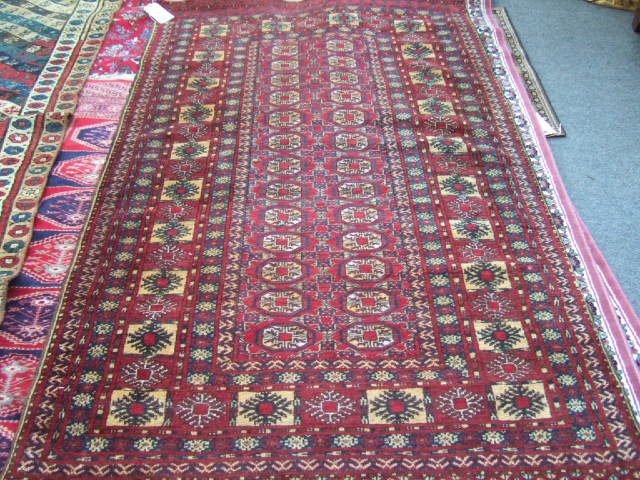 Appraisal: An Afghan Bokhara rug the madder field with two columns