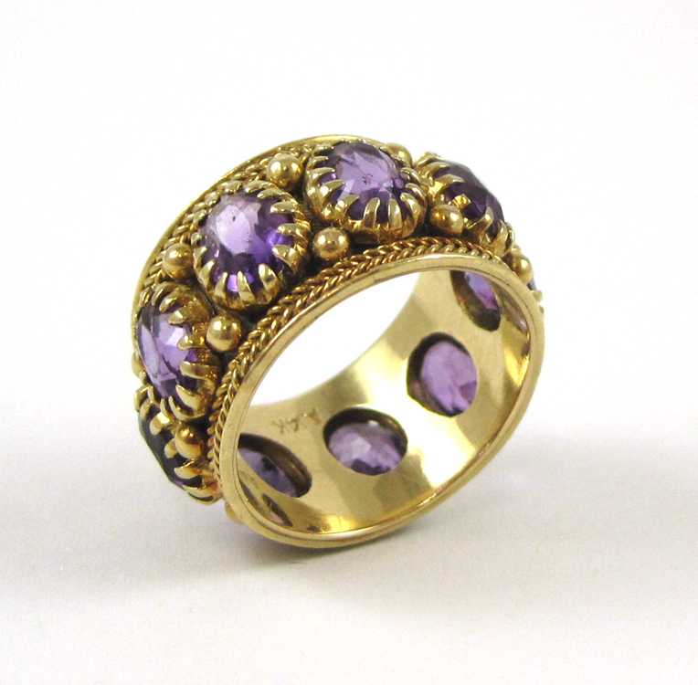 Appraisal: AMETHYST AND FOURTEEN KARAT GOLD RING set with nine oval-cut