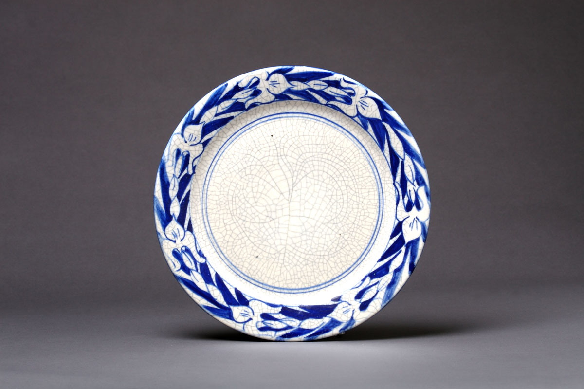 Appraisal: DEDHAM POTTERY 'IRIS' PATTERN PLATE Painted in medium to dark