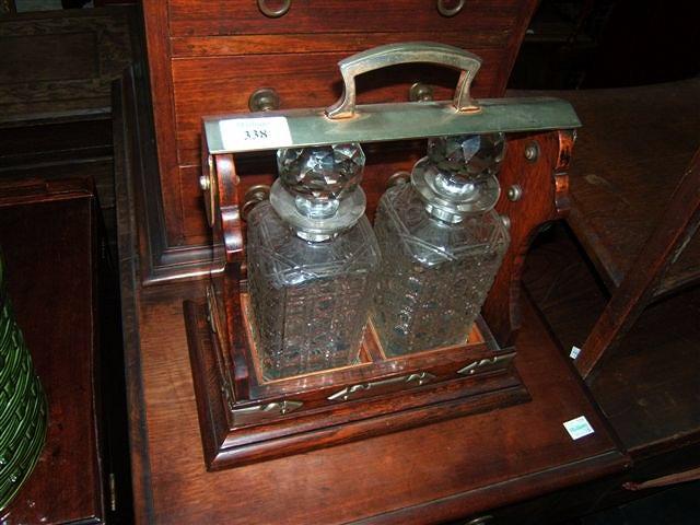 Appraisal: An early th Century oak twin decanter tantalus with silver