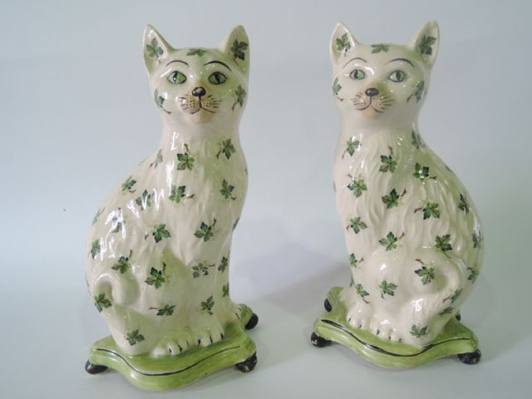 Appraisal: A pair of Staffordshire style models of seated cats with