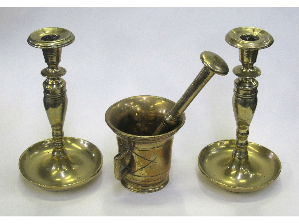 Appraisal: Pair of bronze candlesticks and a bronze pestle and mortar