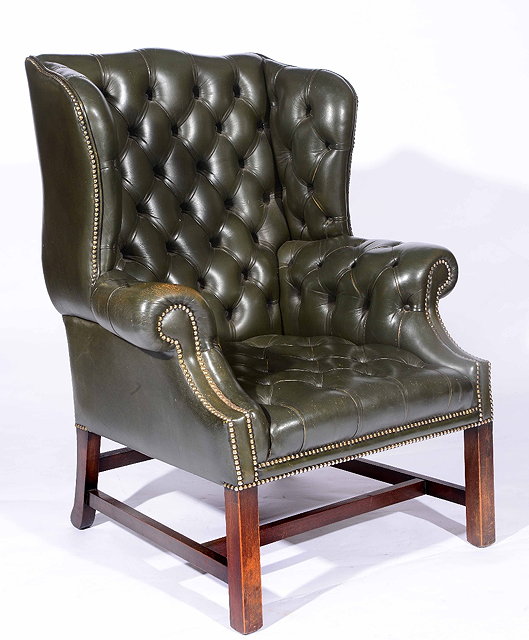 Appraisal: A Georgian style green leather wingback armchair