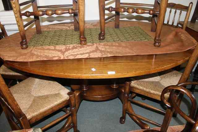 Appraisal: A LARGE GEORGIAN STYLE OAK OVAL DINING TABLE on four