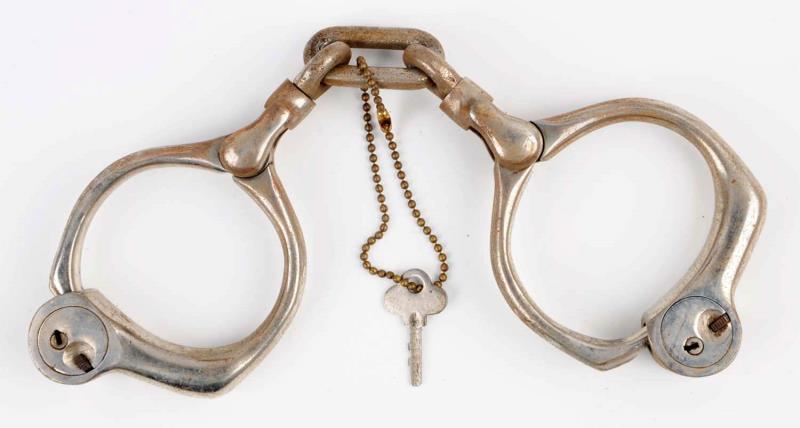 Appraisal: Bean Cobb Style Handcuffs Includes original key Unmarked Slight surface